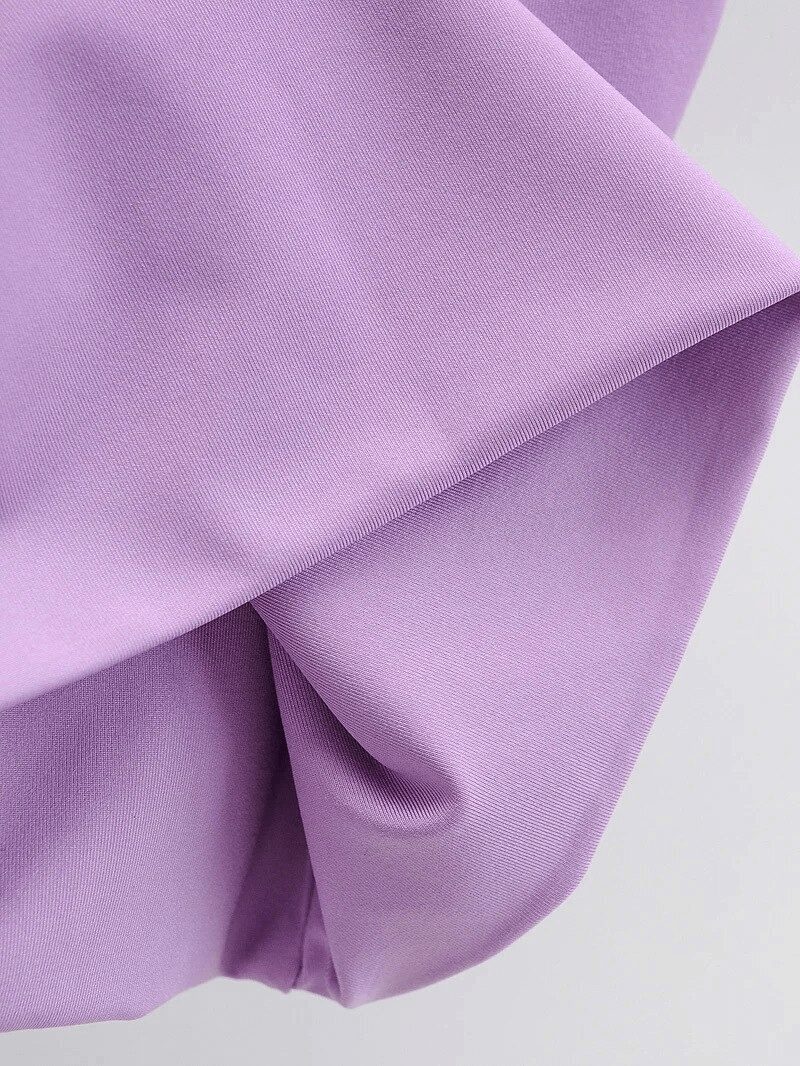 Close-up of purple spandex fabric, showcasing seamless texture and soft folds, perfect for breathable and comfortable athletic wear.